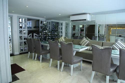 a dining room with a christmas tree and a table and chairs at Elite Central Hotel Hanoi in Hanoi