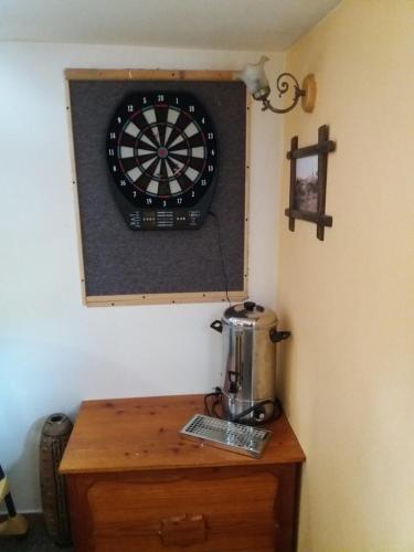 a dart board on a wall next to a table at Chata U Vlastíka in Malá Morávka