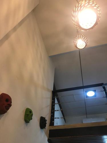 a room with a staircase and two masks on the wall at El Caite Hostel in Granada
