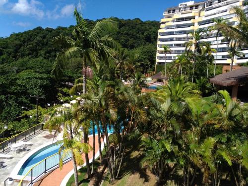 a view of a resort with a pool and a building at Sorocotuba 2 - Enseada in Guarujá