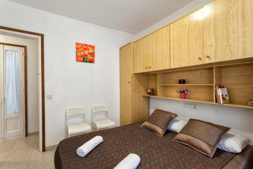 a bedroom with a large bed with two pillows at Maison Lamic 2 in Lloret de Mar