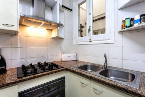 a kitchen with a sink and a stove at Maison Lamic 2 in Lloret de Mar