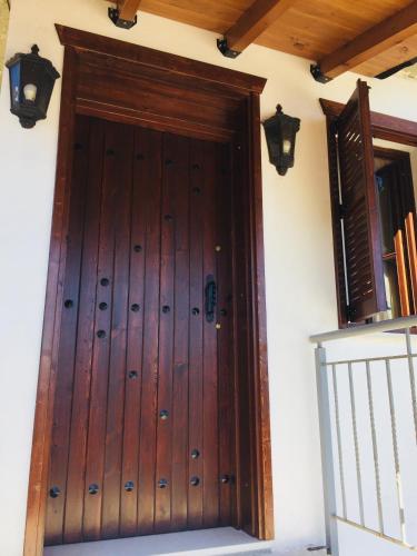 a wooden door on the side of a house at Denis GuestHouse 1930 in Gjirokastër