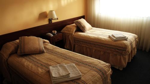 Hotel Centro房間的床