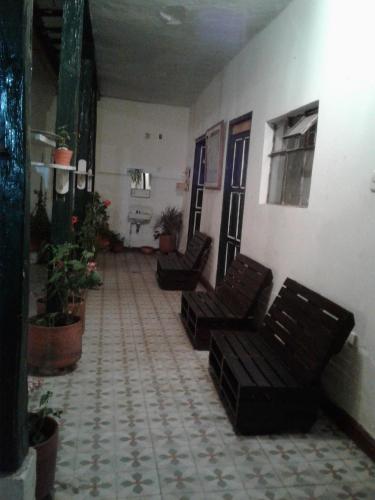 a hallway with two chairs in a building at Casa Vieja Posada in Pesca