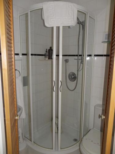 a bathroom with a shower and a toilet at Maison Dieu Guest House in Dover