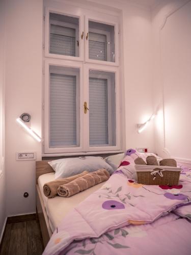 a bedroom with a bed with a window at Centrally Located Relaxing Place in Belgrade