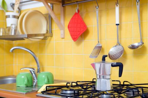 a kitchen counter with a coffee maker on a stove at Il Vicolo B&B in Milazzo