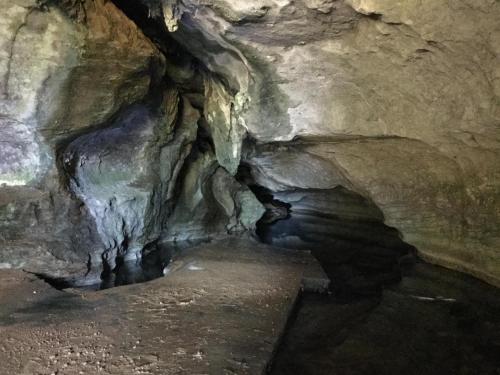 a cave with a tunnel in the middle of it at The Rocks Chalets in Takaka