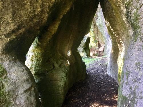 a cave with a path through the rocks at The Rocks Chalets in Takaka