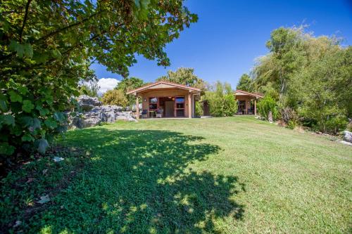 a large yard in front of a house at The Rocks Chalets in Takaka