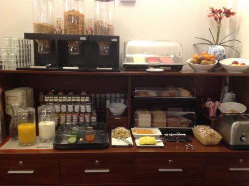 a shelf filled with food and drinks in a kitchen at Hotel Allure in Amsterdam