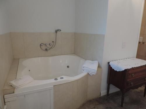 a bathroom with a bath tub and a table at Puerto de Lilas in Las Gaviotas