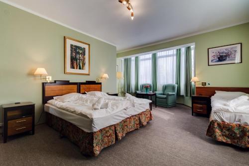 Кровать или кровати в номере Villa Plaza