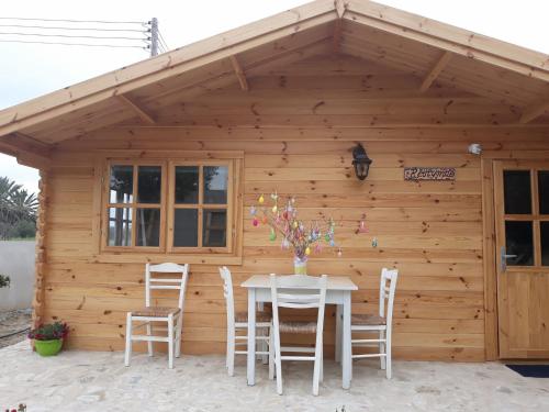 a table and chairs in front of a cabin at Cyprus Glamping Park in Ayios Theodhoros
