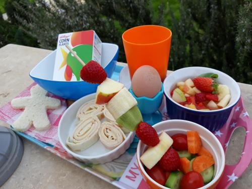 a tray of food with fruits and vegetables on a table at Cyprus Glamping Park in Ayios Theodhoros
