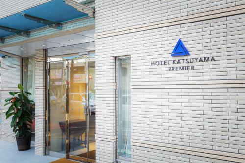 a hotel akureyriacistacist sign on the side of a building at Hotel Katsuyama Premiere in Matsuyama