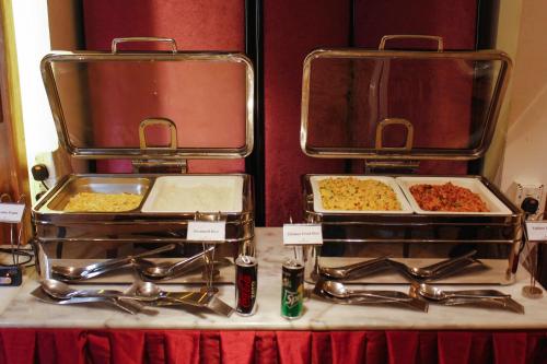two trays of food sitting on top of a table at The Grandmark Dhaka in Dhaka