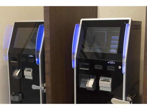 a atm machine in a hotel room with its door open at Hotel Super Tomari in Fujieda