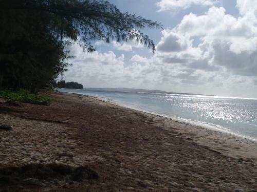 a sandy beach with the ocean in the background at Saipan Beach Hotel in Saipan