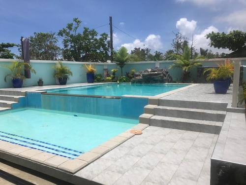 a swimming pool with blue water in a resort at Samoana Boutique Hotel in Apia