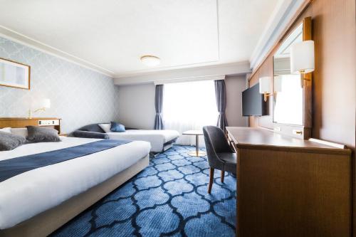 Postel nebo postele na pokoji v ubytování Senri Hankyu Hotel Osaka