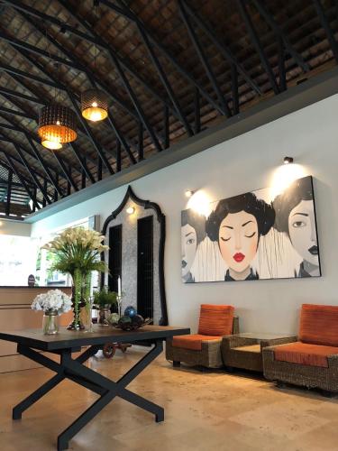 a living room with a table and a couch at Paragon Inn in Lat Krabang