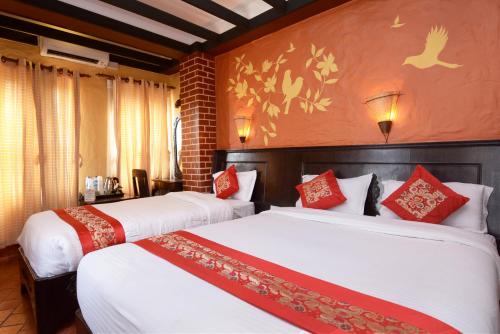 A bed or beds in a room at Kasthamandap Boutique Hotel