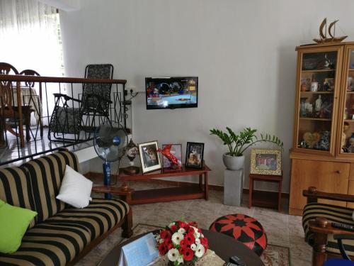 a living room with a couch and a table at Samanala Garden Holiday Home in Hikkaduwa