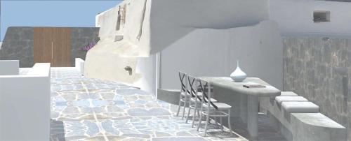 a dining room with a table and chairs in a room at Ianthe Apartments & Villa in Oia