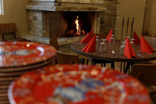 a dining room with tables and a fire place at Santa Claus Holiday Village in Rovaniemi