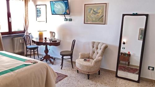 a bedroom with a bed and a mirror and a table at Le stanze di Bruno in Pescara