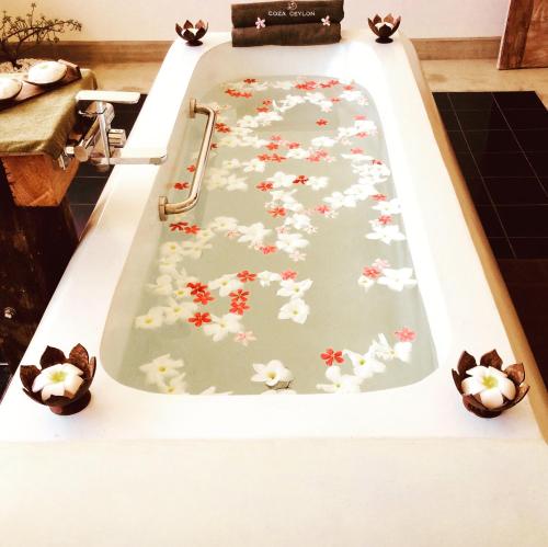 a bath tub decorated with flowers and ducks at Coza Ceylon in Mount Lavinia