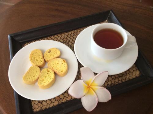 a tray with two plates of biscuits and a cup of tea at Coza Ceylon in Mount Lavinia