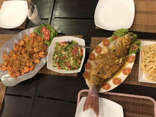 a table with three plates of food and a fork at Rumassala Villas in Unawatuna