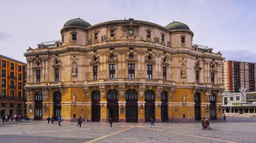 a large building with people walking in front of it at Garai Etxea, casa adosada en la montaña in Arrankudiaga