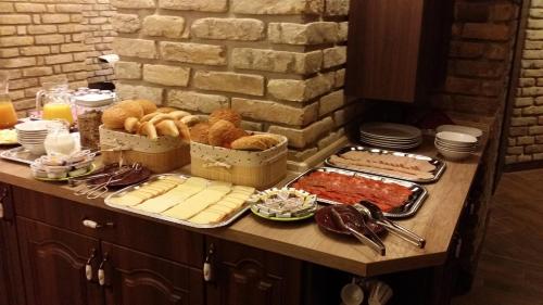 a buffet of food on a table with food at Partium Hotel Szeged in Szeged