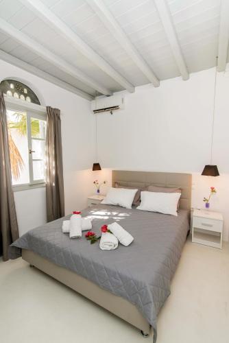 a bedroom with a large bed with towels on it at Santamare Villa in Tinos
