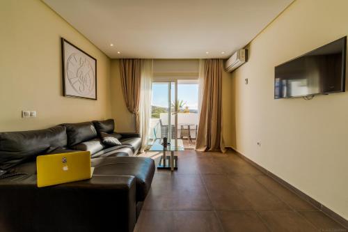 a living room with a couch and a laptop at Mnar Park aqua park in Tangier