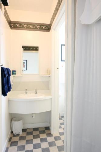 a bathroom with a sink and a mirror at Queens Park Motels in Invercargill