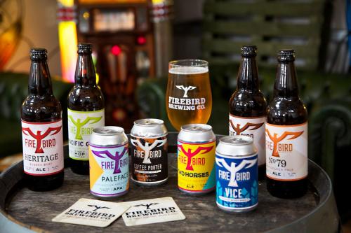 a group of beer bottles andbeer cans on a table at The Coach House in Rudgwick