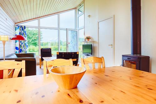 a living room with a wooden table with a wood stove at Mötesplats Borstahusen in Landskrona