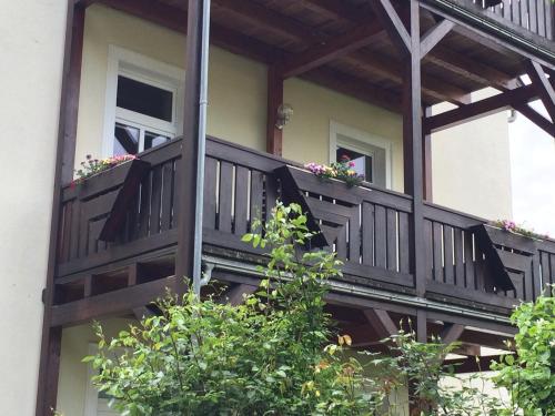 a balcony of a house with flowers on it at Pension Hönel-Hof Bad Schandau in Bad Schandau