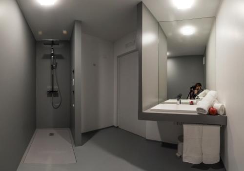 a person taking a picture in a bathroom mirror at NonSoloMele in Romallo