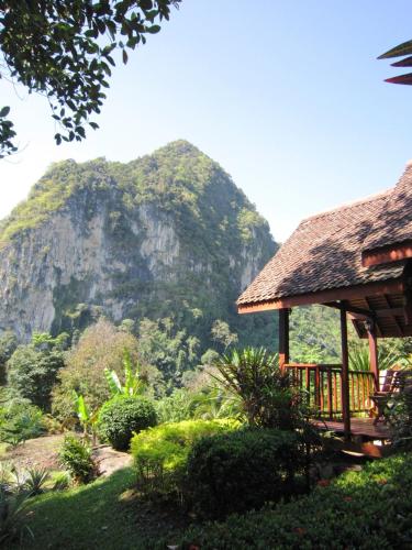 a resort with a mountain in the background at Phanom Bencha Mountain Resort in Krabi