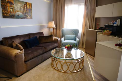 a living room with a couch and a coffee table at Lumiere Des Etoile in Kuwait