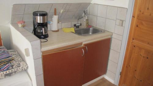 a small kitchen with a sink and a counter at Guesthouse Sharon Aarhus in Aarhus