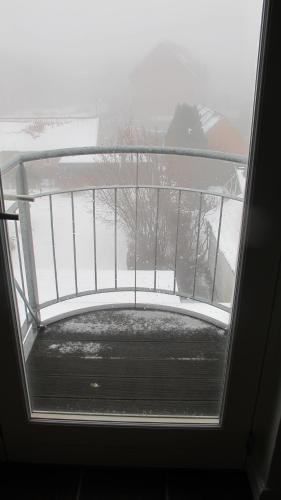 a window in a room with snow on the ground at Guesthouse Sharon Aarhus in Aarhus