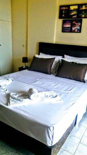 a large white bed in a room at Sunrise Sarelas in Petalidhion