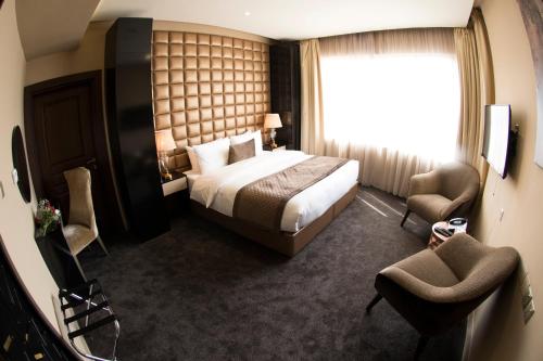 a hotel room with a bed and a window at Lumiere Des Etoile in Kuwait
